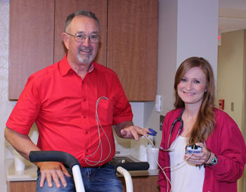 This is a picture of female a nurse doing a test on a elderly male patient for cardiac rehab