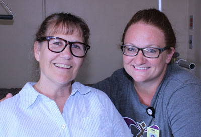 A nurse and a patient smiling.