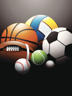 Different sports equipment on green grass